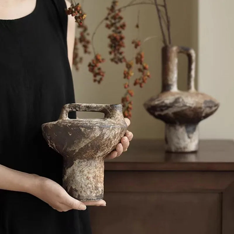 Wabi-sabi stoneware vase shown in hand for scale