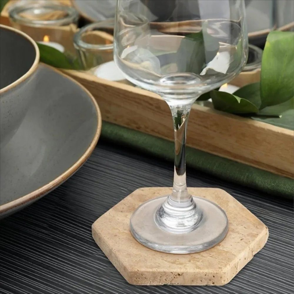 Travertine coaster under a wine glass, table setting