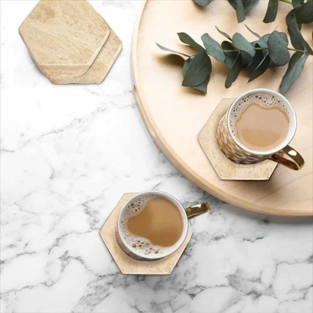 Travertine coasters styled flat-lay on marble with coffee