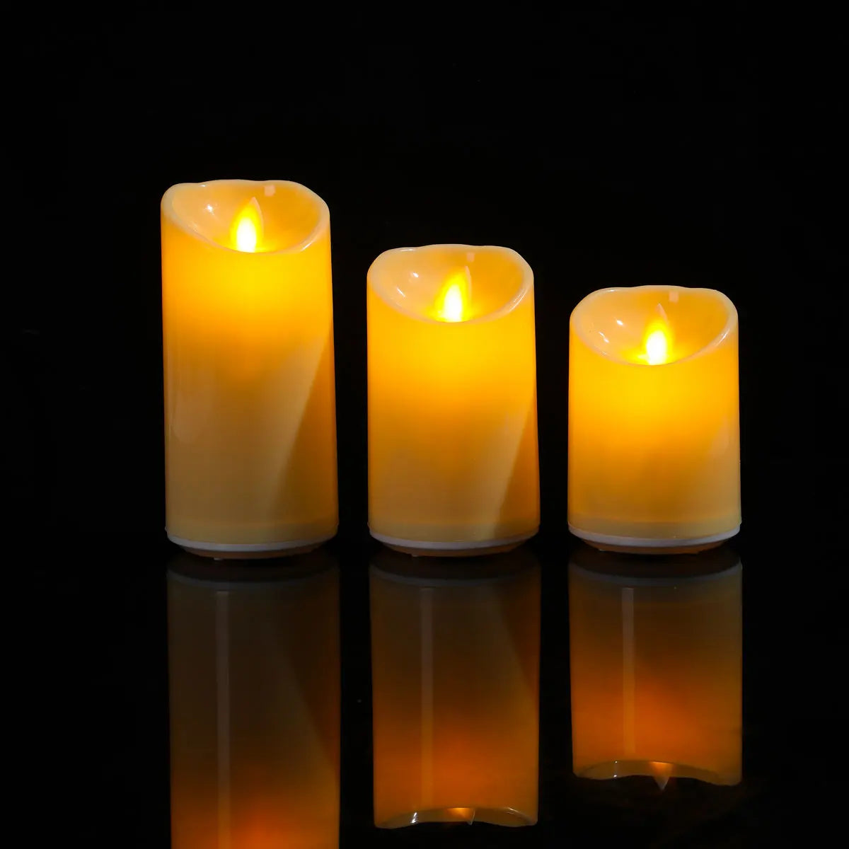 Moving-Flame Flameless Pillar Candles, Set of 3 — staggered trio with realistic LED flame