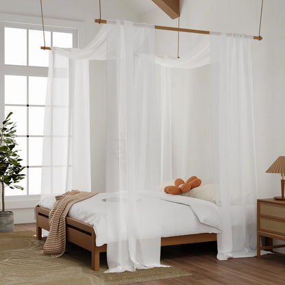 White sheer bed canopy draped over suspended rod above bed